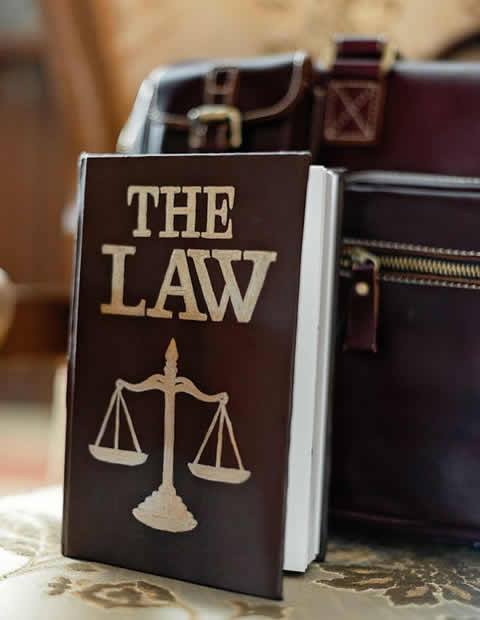 Law Book Next to a Suitcase